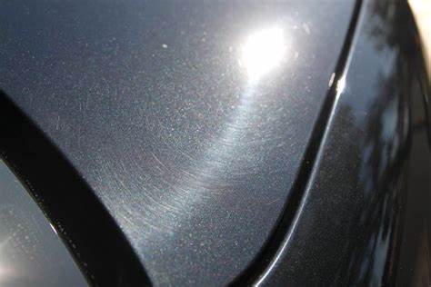example of swirl marks in the paint of a black car