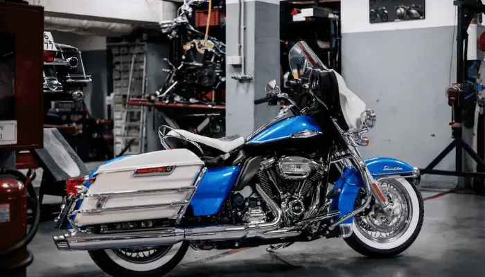 Blue and White Harley Road King in A Mechanic's Shop