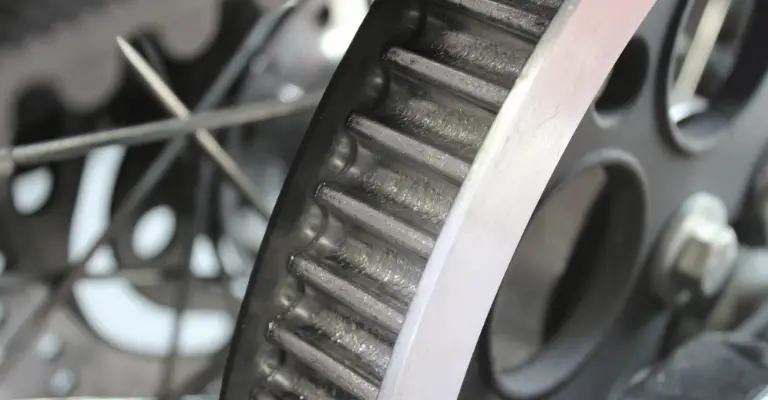 close up of a harley davidsons drive sprocket showing the signs of wear for a drive belt