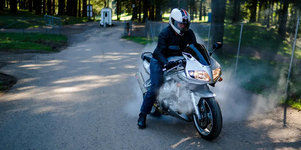 Here's a picture of an SV650 that is overheating. Predominantly, the smoke from the engine is used to illustrate the main symptom of an overheating motorcycle.