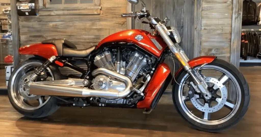 This is a chrome and orange 2003 Harley V-Rod.