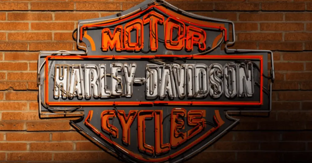 A white, black, and orange Harley Davidson motorcycles neon sign