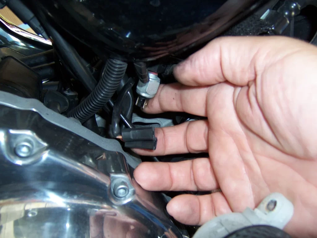 Here's a picture of the rear brake light switch on a Harley Davidson Sportser, a quick solution for a faulty switch is loose wires.