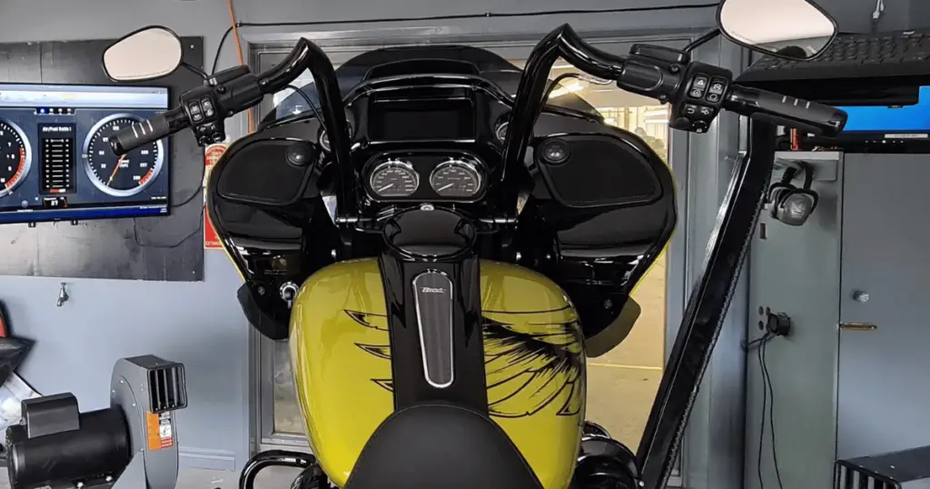 a yellow Harley Davidson Street Glide that is highly customized on the same motorcycle dyno pictured earlier, about to be tuned